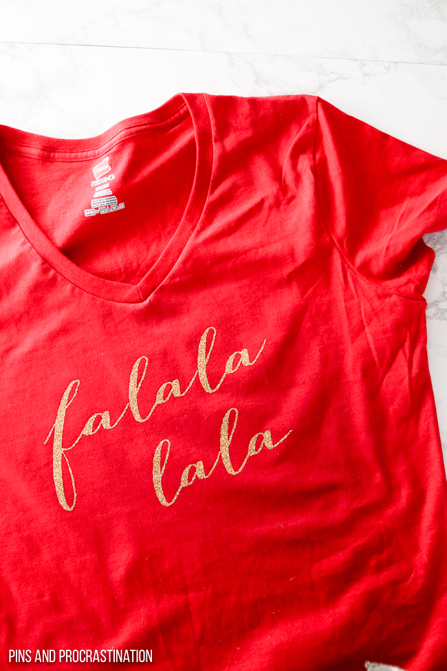 This DIY Christmas shirt is so cute! It's a perfect Christmas craft. You can make this shirt using a Cricut Explore Air and Iron on Vinyl. It is super cute and festive. It makes a great gift idea! 
