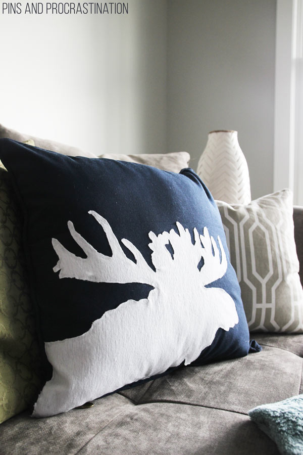 About two months ago I had one of those rare DIY inspirations- where you are suddenly struck with an idea that you know will work and you have to get to it right away. That's how I made this DIY moose pillow! And I was right to be inspired. It has turned into one of my favorite projects and a new decor staple in our home. All for less than 30 minutes of work and $15. And no sewing either! That's a DIY pillow I can get on board with. So keep reading to follow along with how to make this awesome (and easy) DIY moose silhouette pillow!