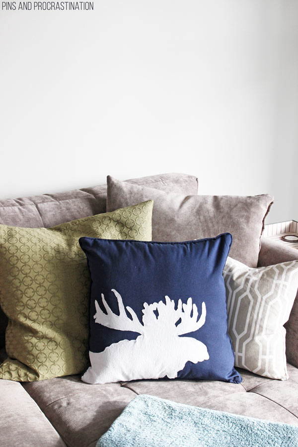 About two months ago I had one of those rare DIY inspirations- where you are suddenly struck with an idea that you know will work and you have to get to it right away. That's how I made this DIY moose pillow! And I was right to be inspired. It has turned into one of my favorite projects and a new decor staple in our home. All for less than 30 minutes of work and $15. And no sewing either! That's a DIY pillow I can get on board with. So keep reading to follow along with how to make this awesome (and easy) DIY moose silhouette pillow!